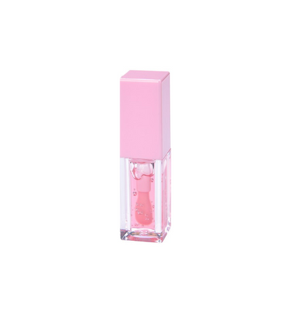 Tube of Pheromones lip gloss with a pink cap and a strawberry-pink gloss inside, standing on a white background.