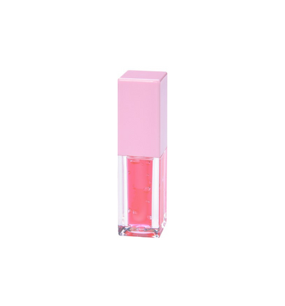 Tube of Pheromones lip gloss with a pink cap and a watermelon-pink gloss inside, standing on a white background.